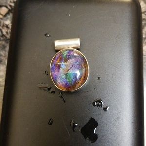 Iridescent glass? pendant in silver. Stamped.
